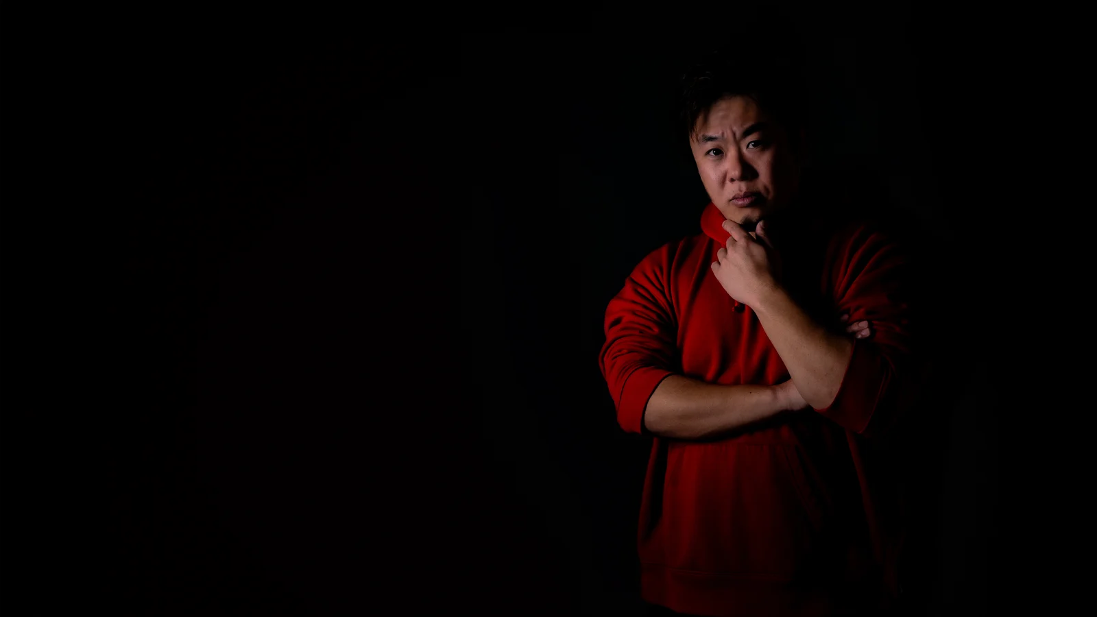 Portrait of Masashi Hasegawa against a dark background.