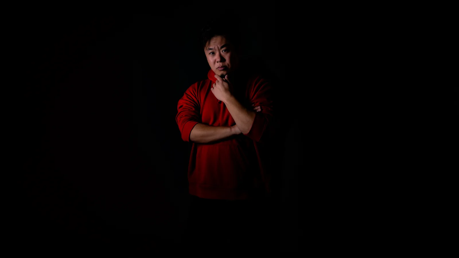 Portrait of Masashi Hasegawa against a dark background.